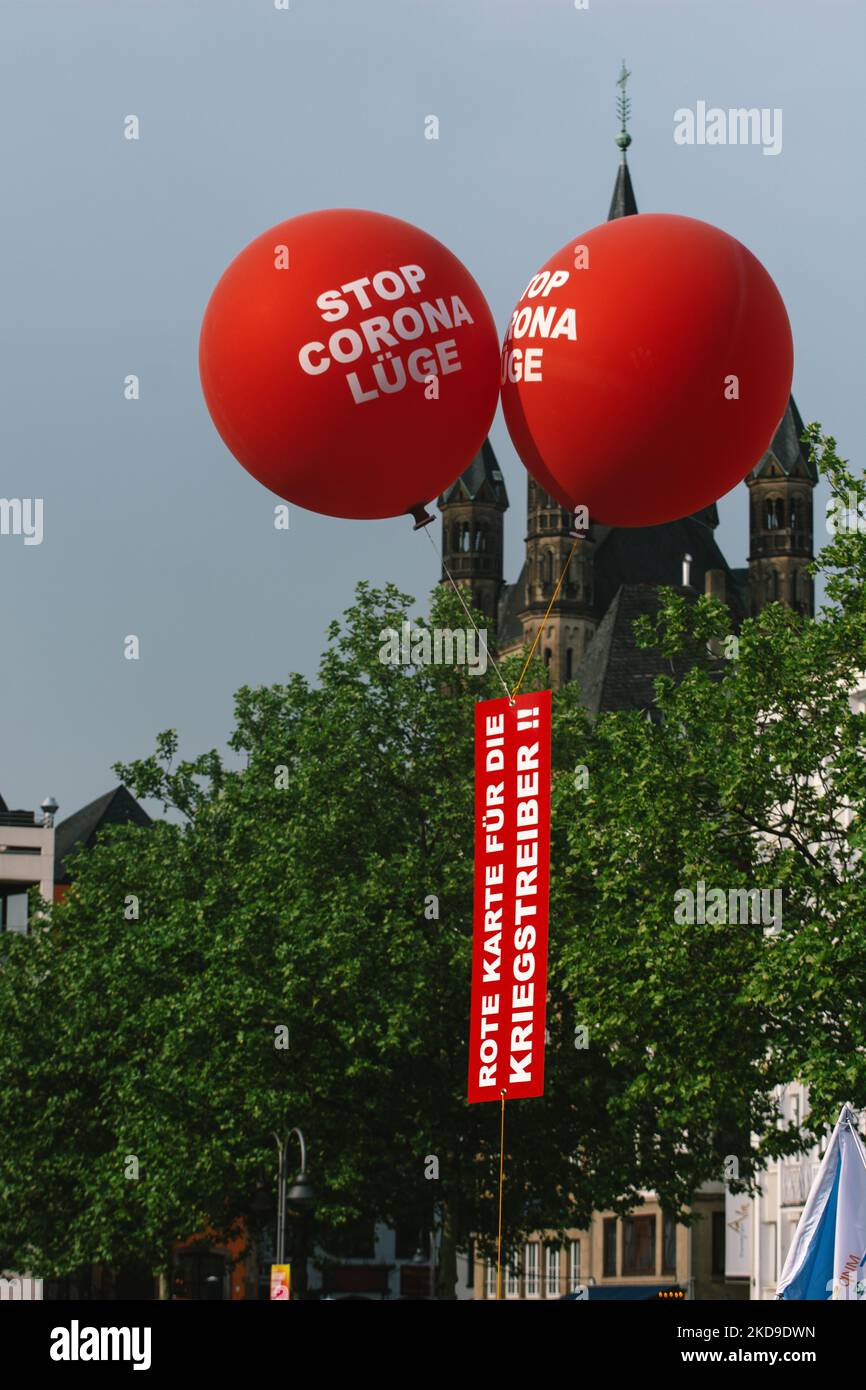 a Banners of 'red card for the warmonger' are seen from protesters from vaccine skeptics groups as foreign minister Annalena Baerbock takes part in Green party`s state election campaign 2022 in Cologne, Germany on May 7, 2022 (Photo by Ying Tang/NurPhoto) Stock Photo